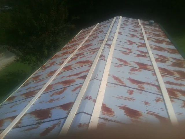 Rusted metal roof panels with new wood purlins before replacement — Storm Damage Roof Repair in Bay Village by Roofing Brothers